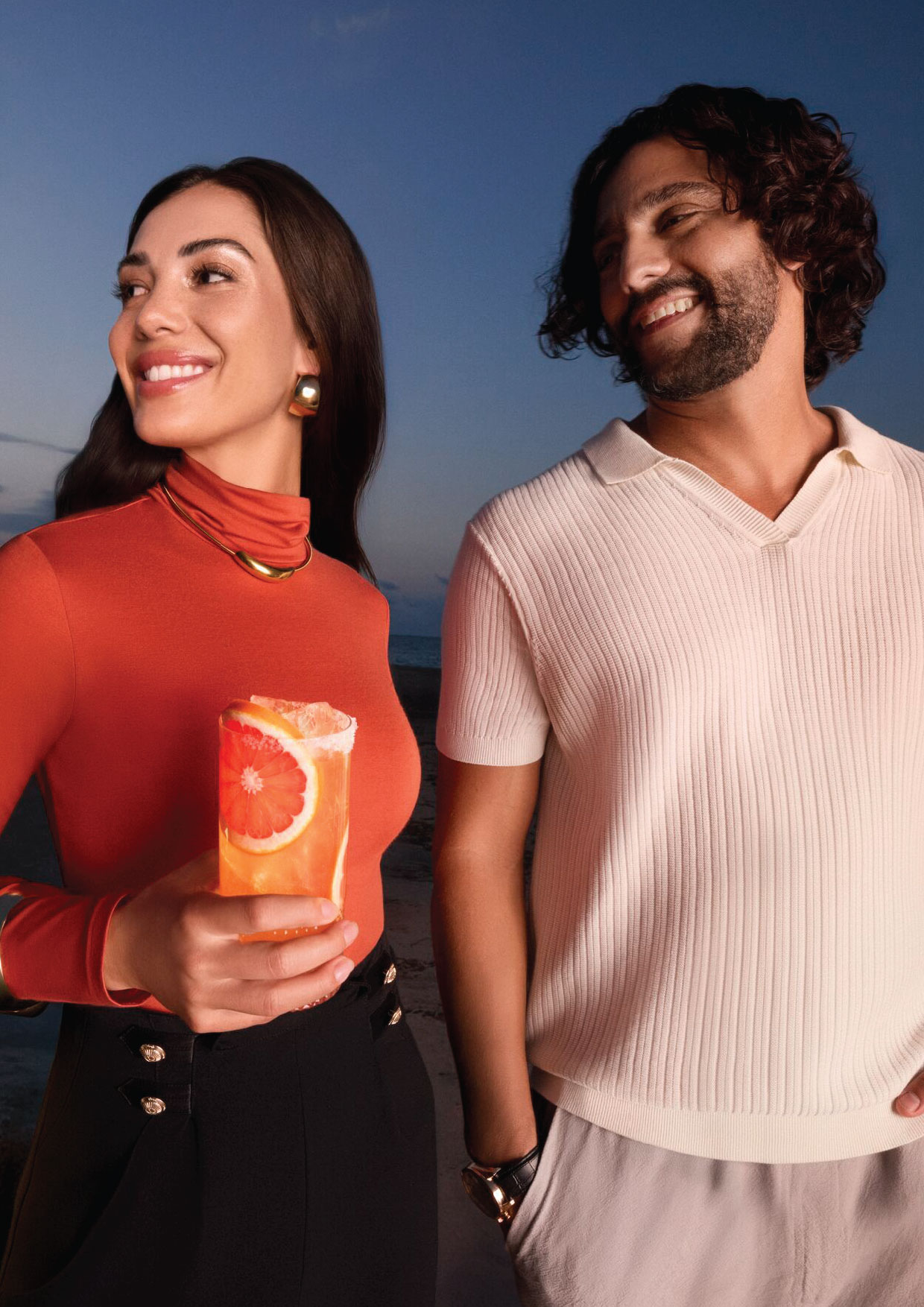 Two guests with a grapefruit serve at dusk